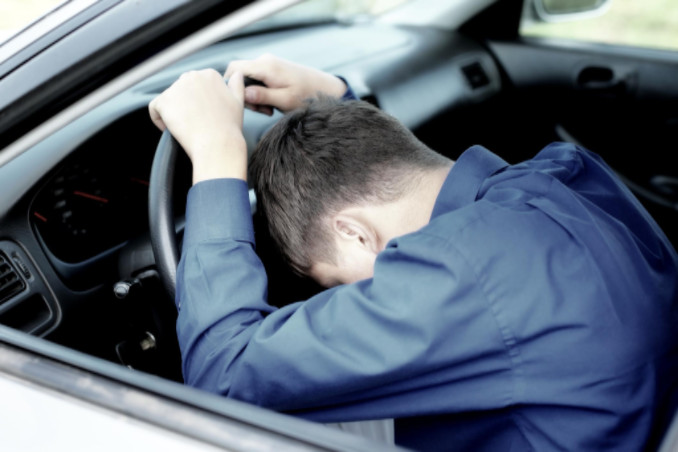 young man asleep at wheel suffers sleep apnea