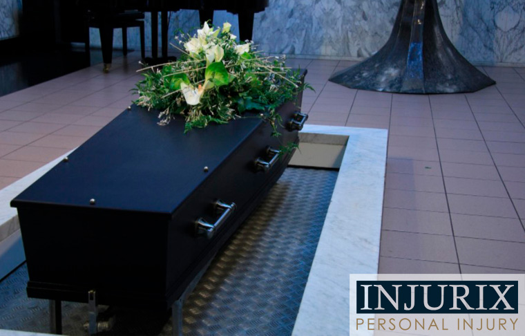 black casket with white flower bouquet on top