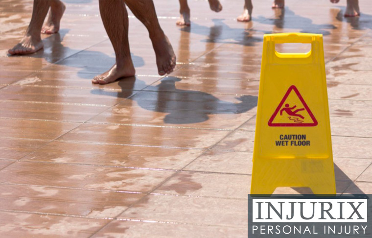 people walking near wet floor sign